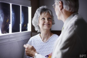 Doctor Discussing X-Rays with Middle Aged Woman